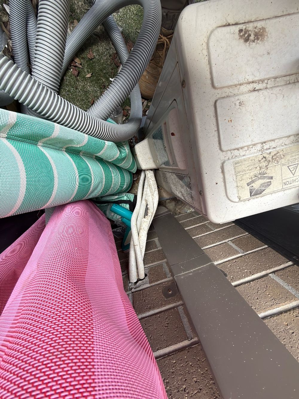 Air conditioner condensate dripping onto the ground against the wall, found during a pre-purchase building and pest inspection in Doreen