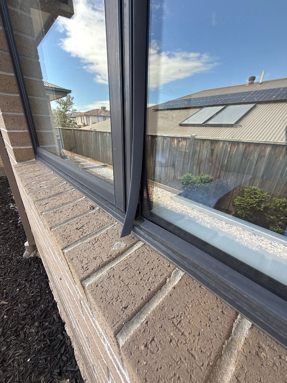 Warped glazing trims on the aluminium windows letting the seal go, found during a pre-purchase building and pest inspection in Doreen