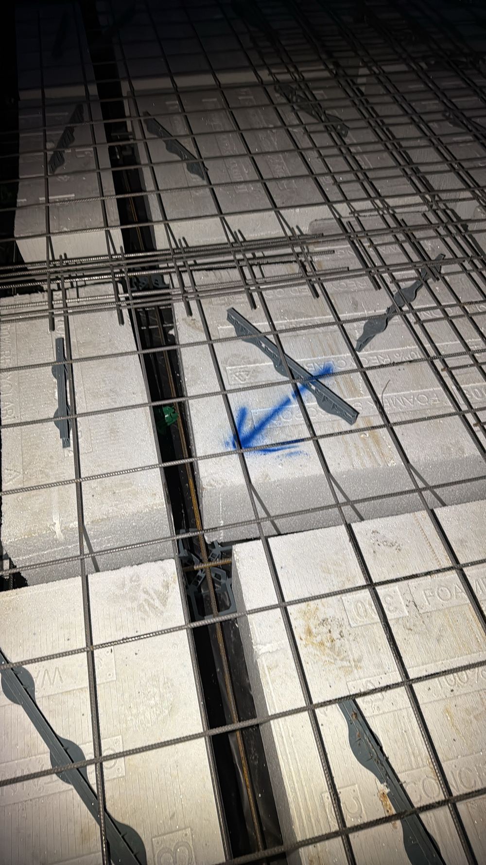 Waffle pods out of position, leaving the middle beams uneven in width and spacing, found during a slab pre-pour inspection in Beveridge