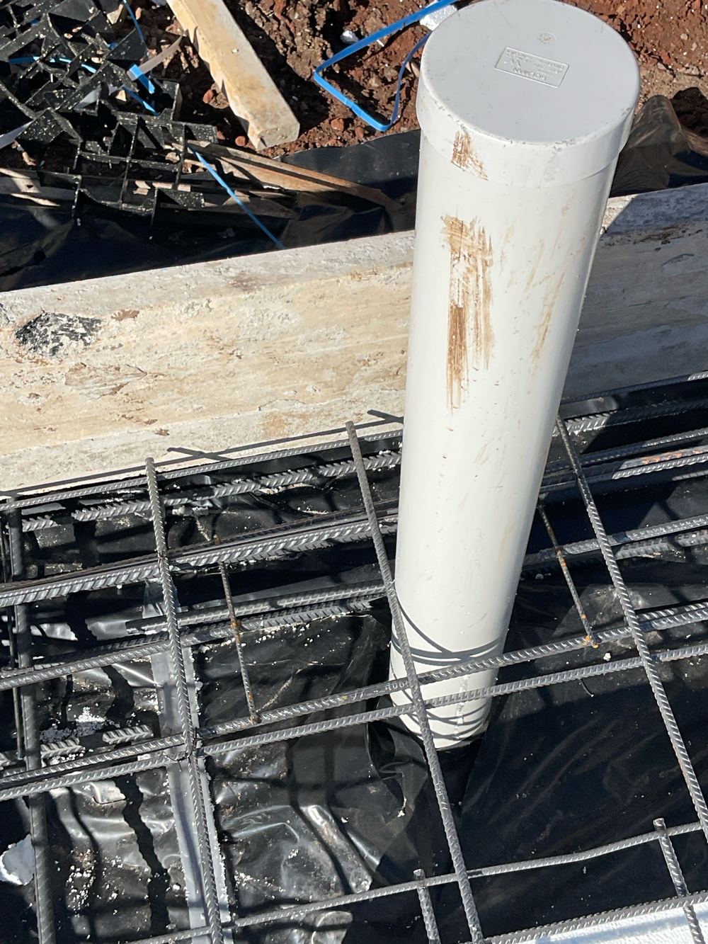 Slab mesh touching service pipes where a 25mm clearance is needed, found during a slab pre-pour inspection in Beveridge